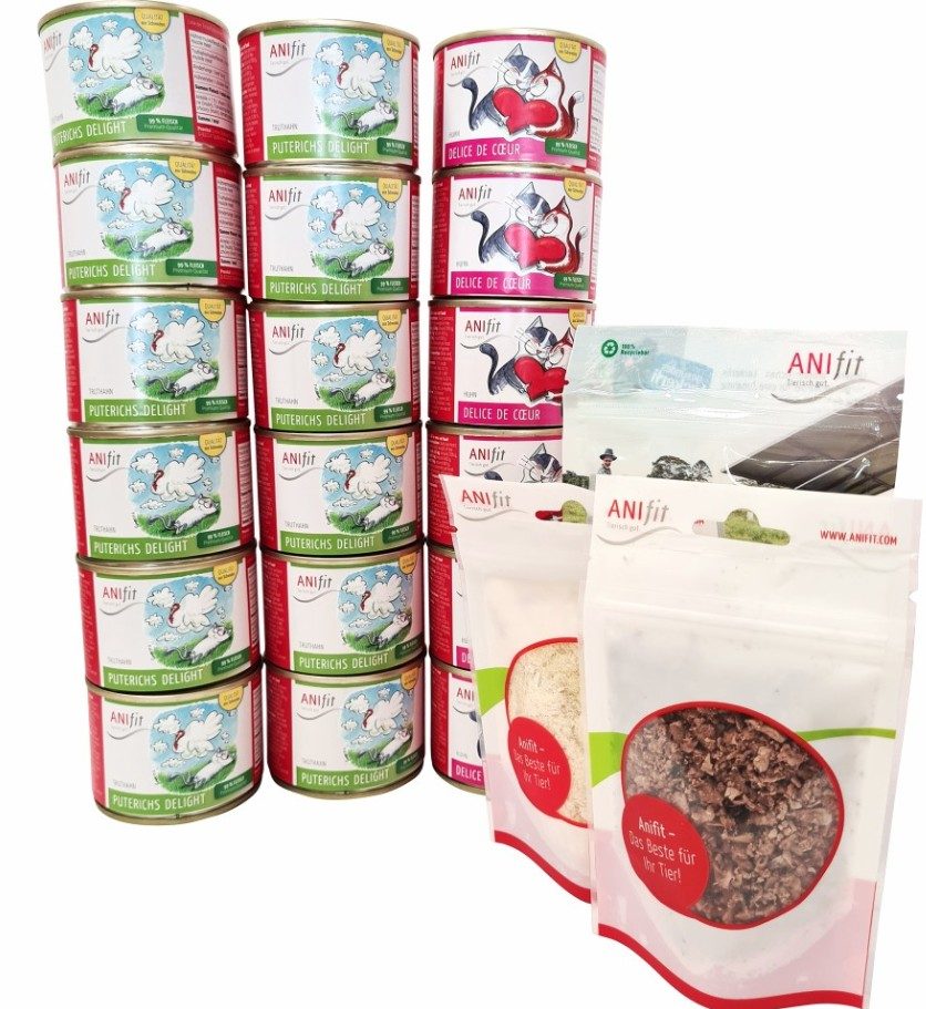 Mehrere Dosen und Snacks von ANIfit in verschiedenen Sorten. Ansprechend arrangiert vor weißem Hintergrund.